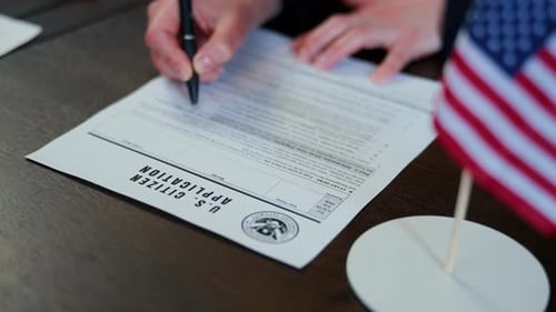 Signing US Citizen Application Form with US Flag