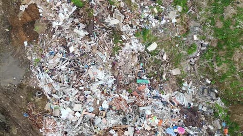 Aerial View Shows Scattered Trash in a Grassy Area