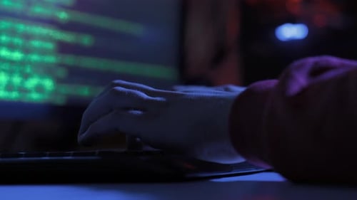Hacker hands typing very fast on keyboard.