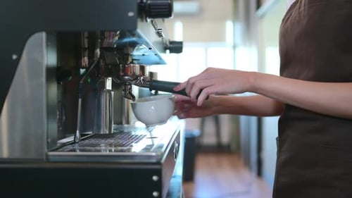 Woman Prepares Espresso Drink with Precision