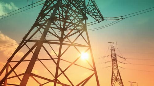Time Lapse View of Clouds Hovering Over an Electrical Tower at Sunrise