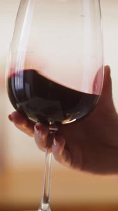 Hand Swirling Red Wine in a Glass