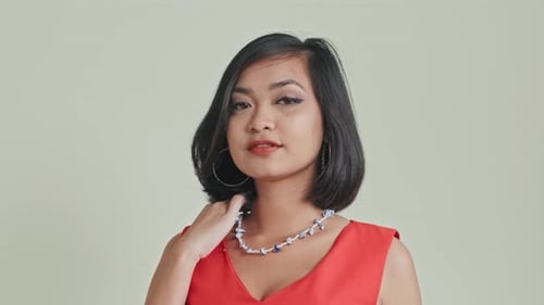 Young Woman Poses in Red Top and Necklace