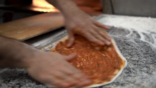 Chef of bakery making a Turkish pizza or lahmacun 4K
