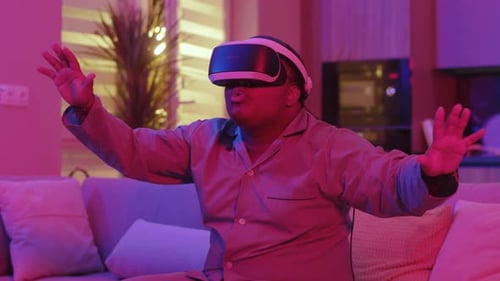 Man Experiencing Virtual Reality on Couch at Home