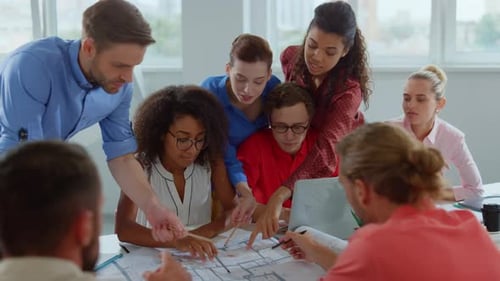 Group Of Business People Communicating In Modern Office. Team Of Young Architects Working On Cons...