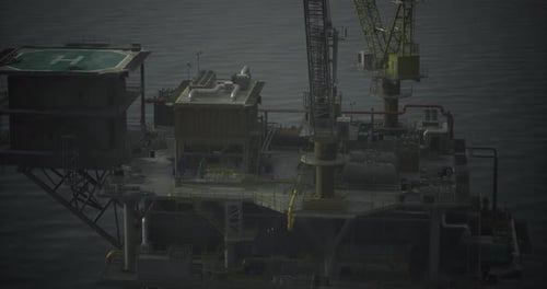 Offshore Oil Platform Operates Near Calm Ocean Waters at Dusk