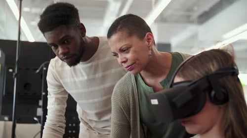Girl Using VR Headset with Adults Helping Her