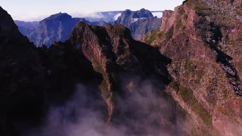 Aerial view over rocky peaks, in Pico Do Arieiro, Madeira - rising, drone shot