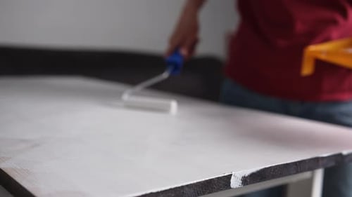 Adult Painting Wooden Surface White With Paint Roller
