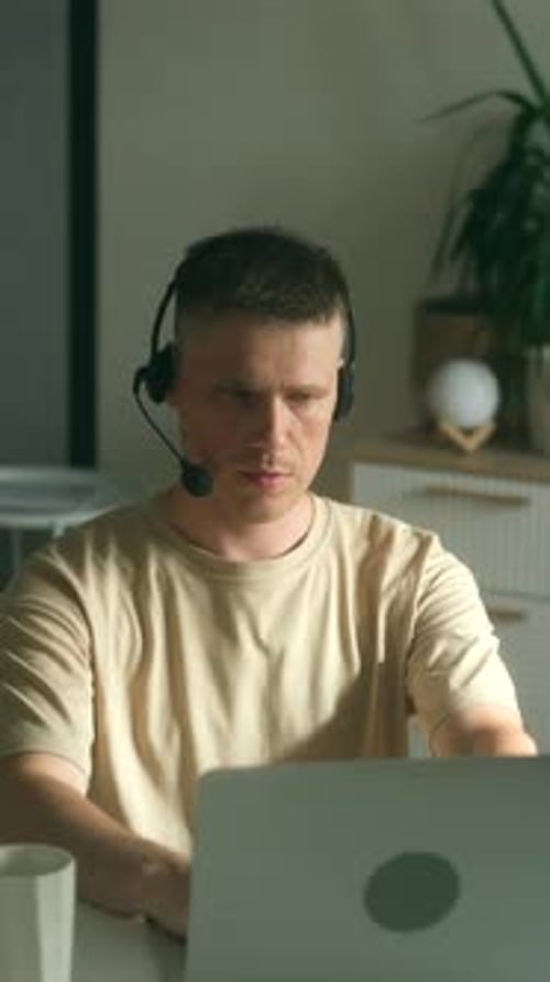 Focused Man Working At Home on Laptop