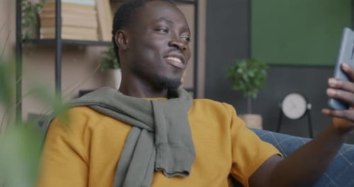 Young Man Chatting on Phone Video Call Indoors