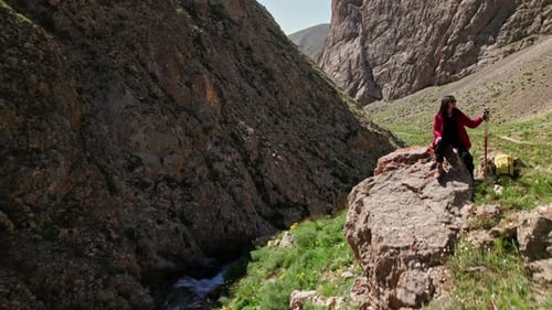 Hiker Traveler Sitting on Cliff