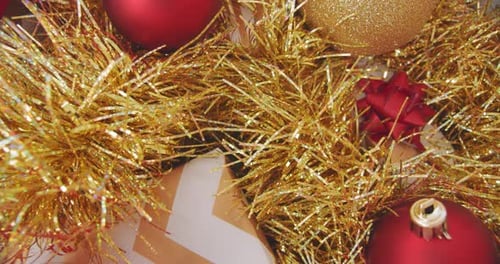 Close up christmas ornaments. Golden and Red decorations. Tinsel garland baubles gift. December wint