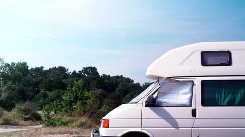 Camper Van Parked near Trees on a Sunny Day