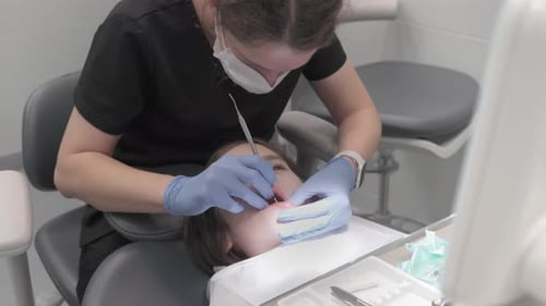 Dentist Examining Child's Teeth in Clinic