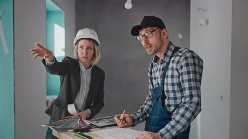 Construction Planner Talking With Foreman Reviewing Blueprint