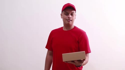 Man in Red Shirt Holding Box
