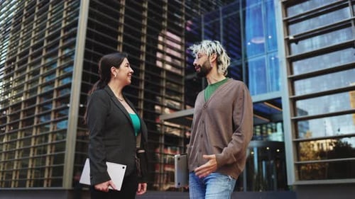 Business people talking outside office building