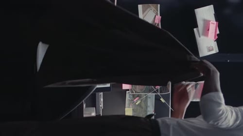 Detective Investigating Case with Strings and Evidence