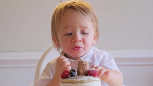 Cute Toddler Eating Delicious Birthday Cake