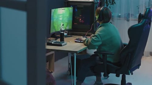 Delighted Female Gamer Completing Level in FPS and Cheering