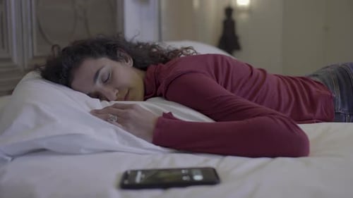 Woman Rests in Bed then Picks Up Phone