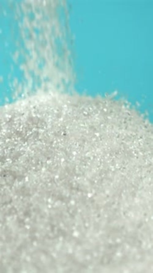 Sugar Falling in a Pile on a Blue Background Filmed on a Highspeed Camera at 1000 Fps