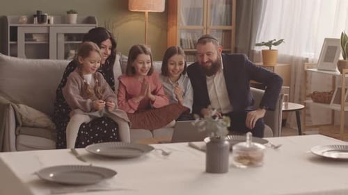 Happy Family Video Calling from Home on Laptop