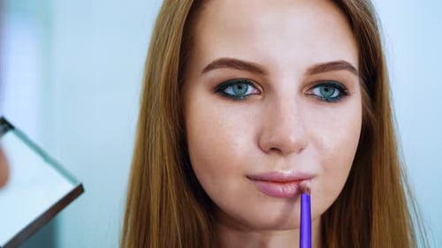 Woman Applying Lip Gloss Close Up