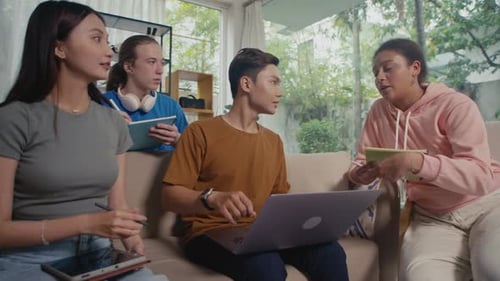 Group of Friends Working Together on Couch Indoors