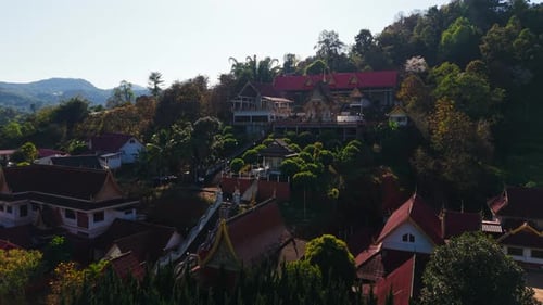 Wat Pong Yaeng Nok Buddhist Temple Located on a Hillside is Shown From Various Aerial Perspectives
