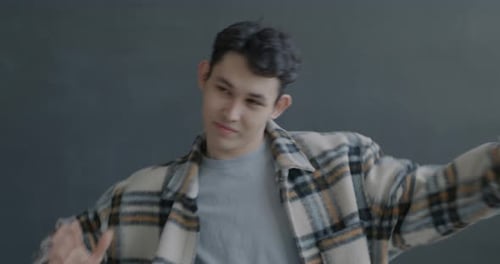 Young Adult Dancing in Plaid Flannel