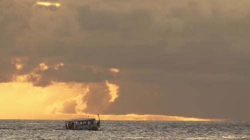 Boat sailing on the ocean at sunset