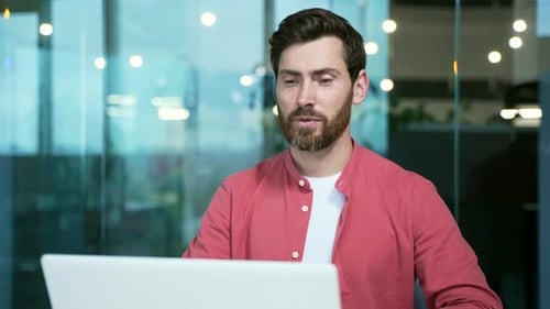 mature bearded businessman entrepreneur talking online on video call sitting in office at workplace