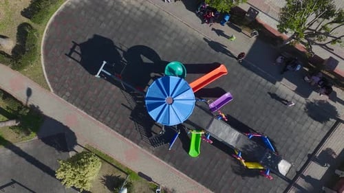 Luftvideo des Spielplatzes mit bunten Rutschen und Kindern