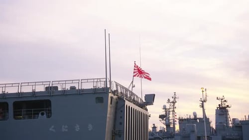 Japanese Warships Docked in Peaceful Urban Harbor