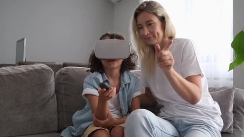 Child Wearing VR Headset with Adult Indoors