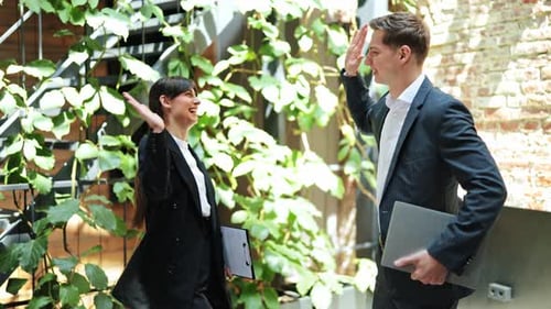 Business Partners Celebrating Success with High Five in Modern Office