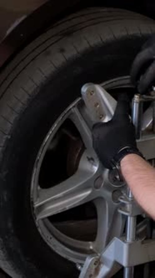 The Master Makes the Camber of the Wheels of the Car Balancing the Chassis of the Car Vertical