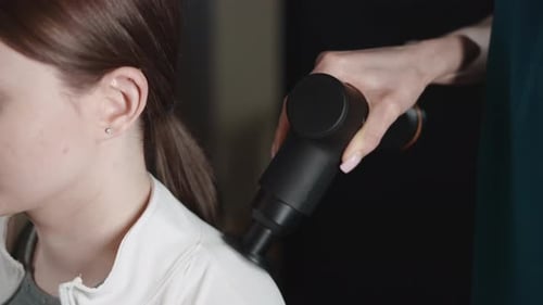 Massage Using a Massage Gun in a Sports Rehabilitation Clinic