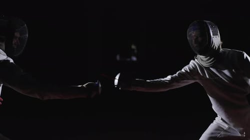 Two Fencers On Fencing Rack Medium Side View With Two Professional Swordsmen Fighting In Darkness