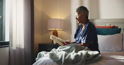 Bedroom, glasses and old woman with book for reading, literature knowledge and retirement at night