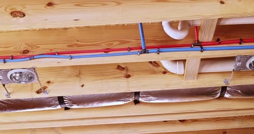 Colorful Pipes and Wiring Under Wooden Structure