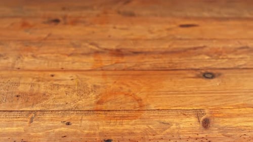 Close-up of a gin and tonic cocktail on a wooden table in a restaurant.