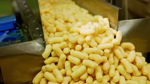 Snacks on Conveyor Belt in Food Factory