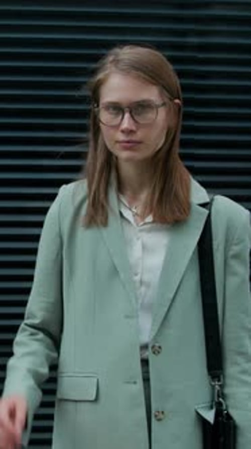 Street Portrait of Business Girl with Glasses Posing for Camera