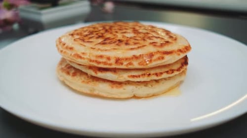 Delicious Pancakes Stacked and Covered in Syrup