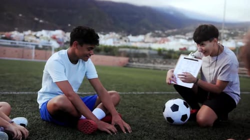 School children with coach teacher during sport training session at soccer field