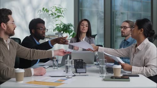 Multiracial Business Group Teamwork Businesspeople Women Men Sharing Graphs Charts Documents